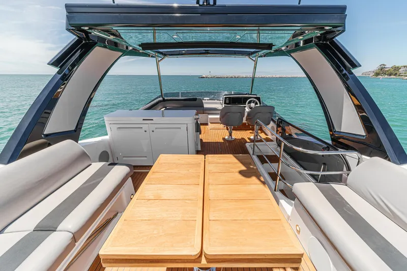 Slide: The Image of Luxurious Sunseeker Manhattan 55 yacht interior with ocean view, featuring elegant seating and dining area. - 17