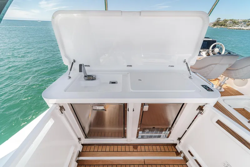 Slide: The Image of Outdoor kitchenette on 2022 Sunseeker Manhattan 55 yacht with sink and storage, ocean view. - 18