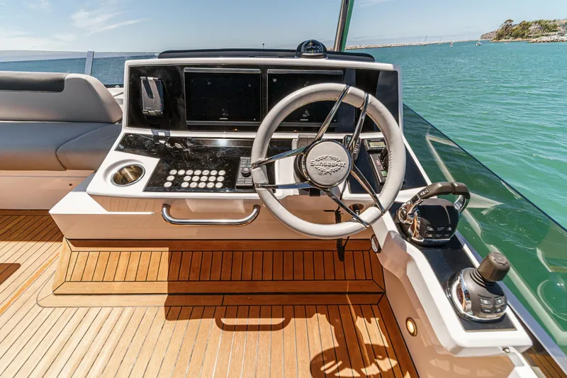 Slide: The Image of Helm of 2022 Sunseeker Manhattan 55 yacht with modern controls and ocean view. - 21