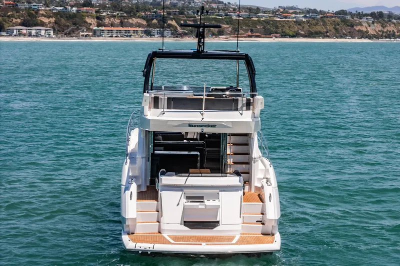 Slide: The Image of 2022 Sunseeker Manhattan 55 yacht on open water, rear view. - 23