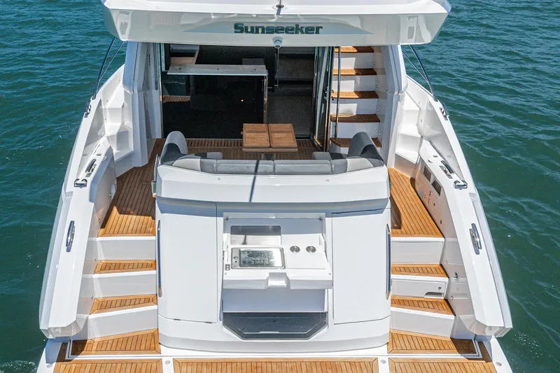 Slide: The Image of Sunseeker Manhattan 55 yacht, 2022 model, featuring elegant deck and seating area. - 24