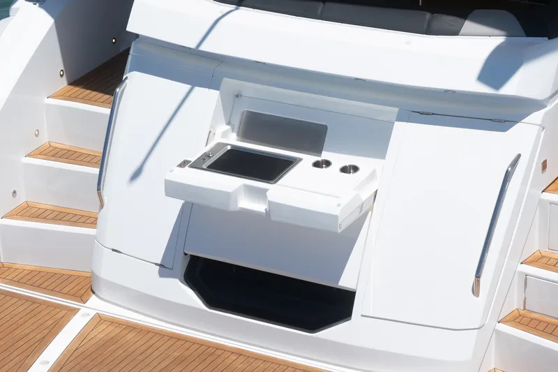 Slide: The Image of Sunseeker Manhattan 55 yacht, 2022 model, featuring a sleek outdoor kitchen area. - 25