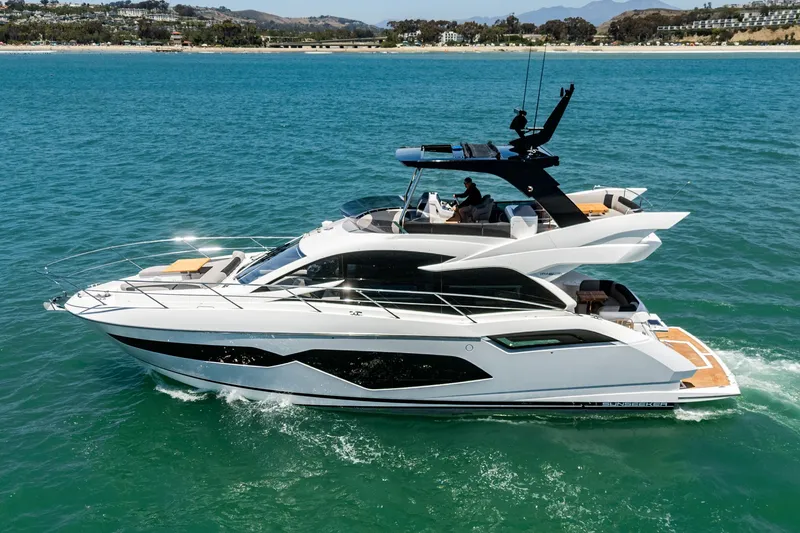 Slide: The Image of 2022 Sunseeker Manhattan 55 yacht cruising on clear blue water. - 4