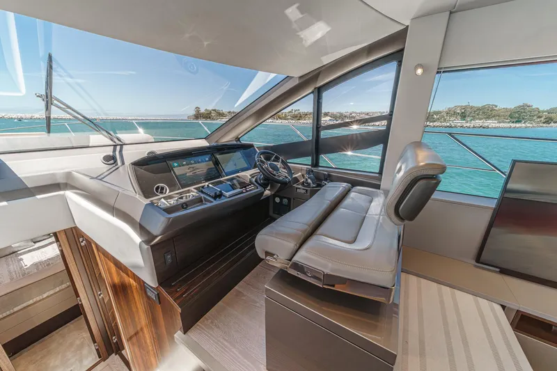 Slide: The Image of Luxurious 2022 Sunseeker Manhattan 55 yacht helm with panoramic ocean view. - 46
