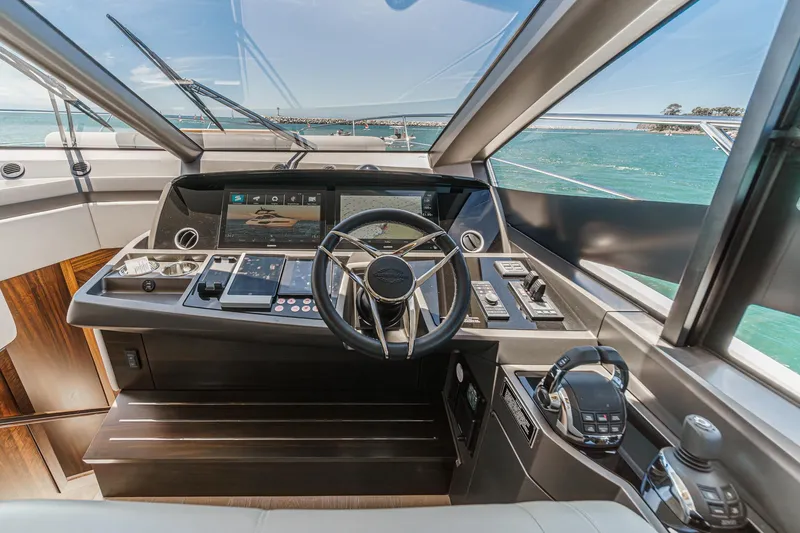 Slide: The Image of Luxurious 2022 Sunseeker Manhattan 55 yacht cockpit with modern controls and ocean view. - 47