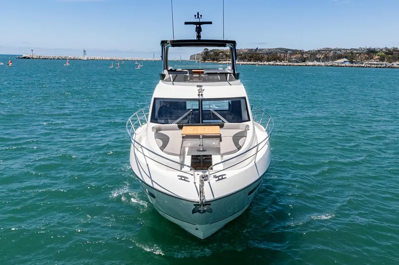 Slide: The Image of 2022 Sunseeker Manhattan 55 yacht cruising in clear blue waters. - 9