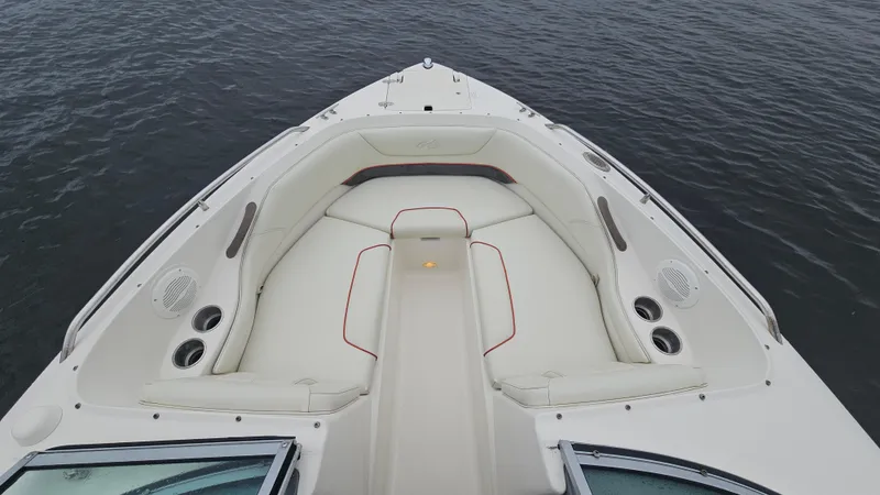 Slide: The Image of 2007 Monterey 214FS Montura boat with white seating and cup holders on calm water. - 16