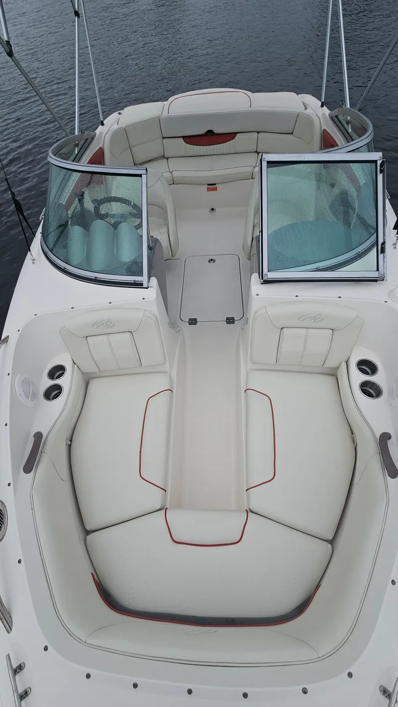 Slide: The Image of 2007 Monterey 214FS Montura boat with white seating and open windshield on calm water. - 18