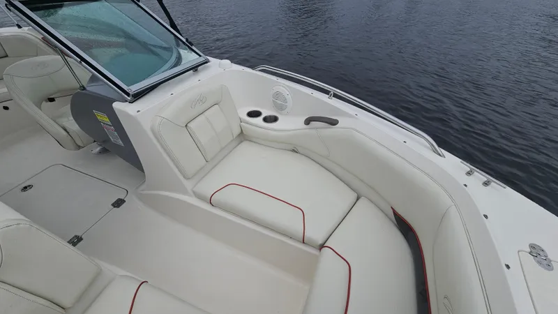 Slide: The Image of 2007 Monterey 214FS Montura boat interior with white seating and cup holders. - 21