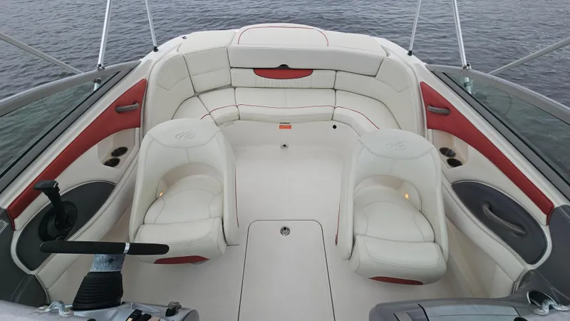Slide: The Image of 2007 Monterey 214FS Montura boat interior with white and red seating, on calm water. - 22