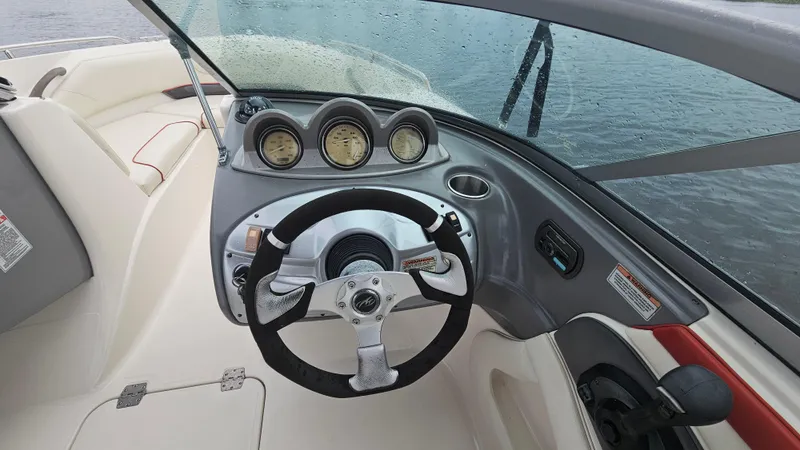 Slide: The Image of 2007 Monterey 214FS Montura boat dashboard with steering wheel and gauges. - 26