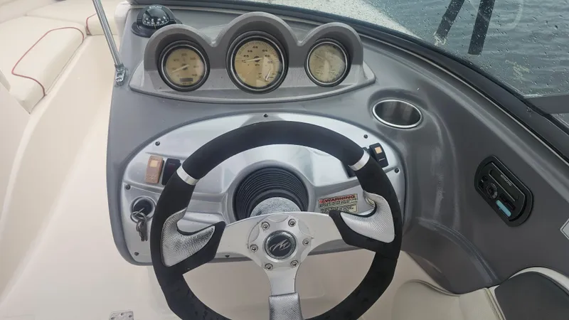Slide: The Image of Steering wheel and dashboard of 2007 Monterey 214FS Montura boat, featuring gauges and controls. - 27