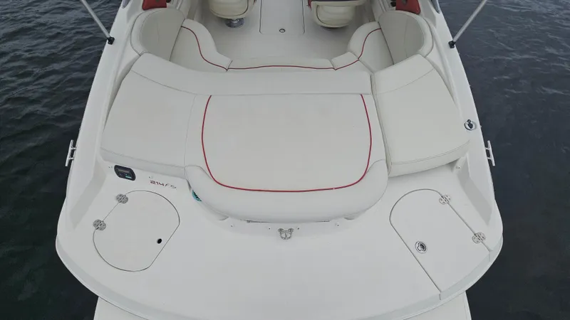 Slide: The Image of 2007 Monterey 214FS Montura boat with white seating and red accents on water. - 30