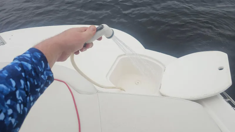 Slide: The Image of Hand holding a hose on a 2007 Monterey 214FS Montura boat deck. - 31