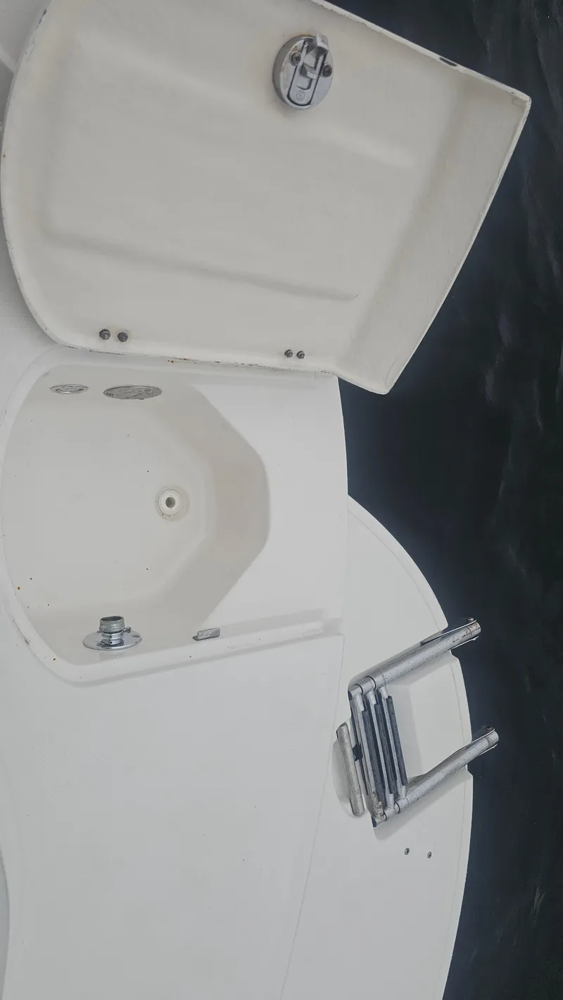 Slide: The Image of 2007 Monterey 214FS Montura boat with open storage compartment and ladder. - 32