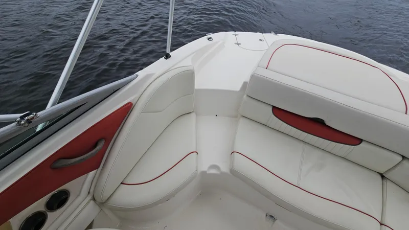 Slide: The Image of 2007 Monterey 214FS Montura boat interior with white and red seating, on water. - 36