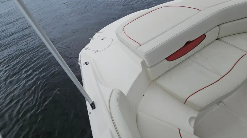 Slide: The Image of 2007 Monterey 214FS Montura boat interior with white and red seating, near water. - 37