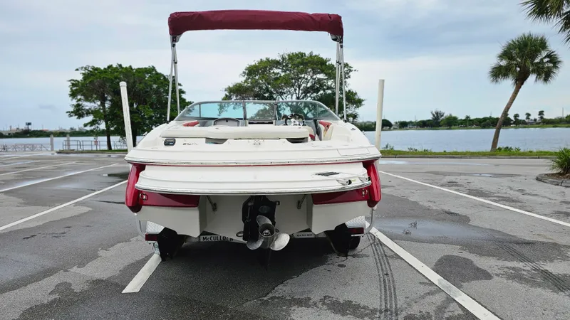 Slide: The Image of 2007 Monterey 214FS Montura boat parked near a scenic waterfront. - 4