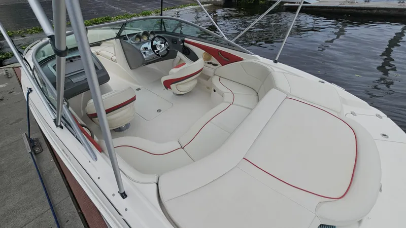 Slide: The Image of 2007 Monterey 214FS Montura boat interior with white and red seating, docked by the water. - 43