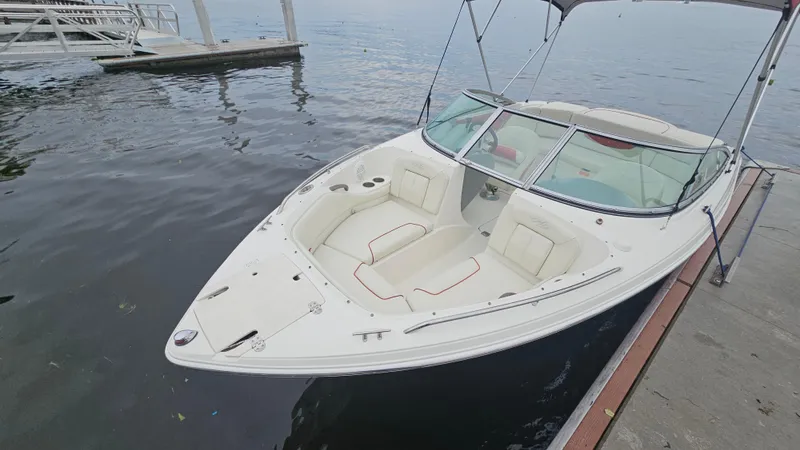 Slide: The Image of 2007 Monterey 214FS Montura boat docked on calm water, featuring spacious seating and sleek design. - 45