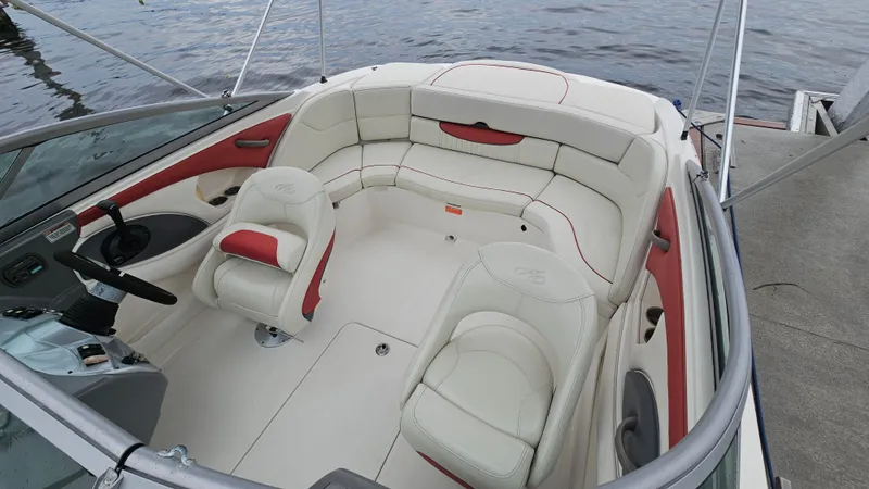 Slide: The Image of 2007 Monterey 214FS Montura boat interior with white and red seating, docked by the water. - 46