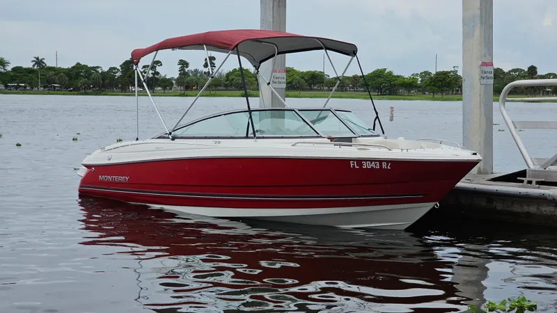 Slide: The Image of Red 2007 Monterey 214FS Montura boat docked on a calm lake. - 47