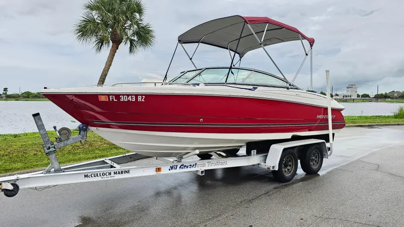 Slide: The Image of 2007 Monterey 214FS Montura boat on trailer by a lake, overcast sky. - 48