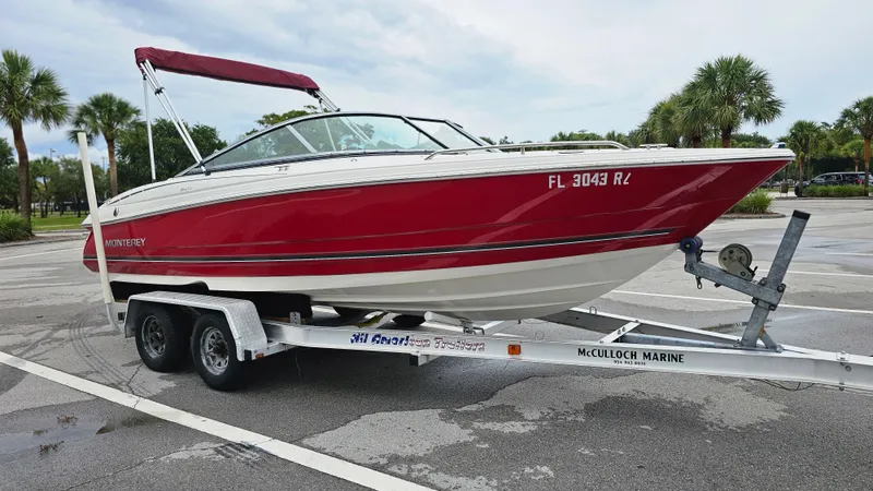 Slide: The Image of 2007 Monterey 214FS Montura boat on trailer in parking lot with palm trees. - 6
