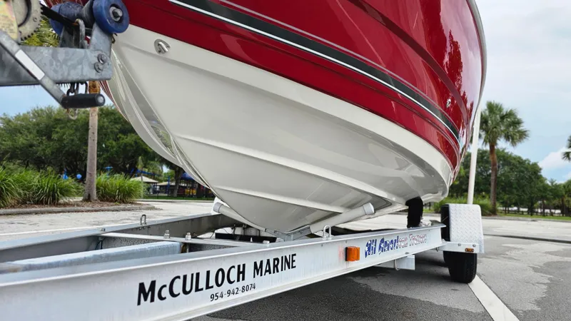 Slide: The Image of 2007 Monterey 214FS Montura boat on trailer, red hull, parked outdoors. - 8