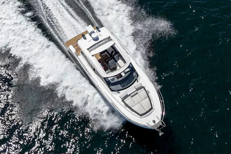Slide: The Image of 2023 Bavaria SR36 yacht cruising on open water, aerial view. - 12