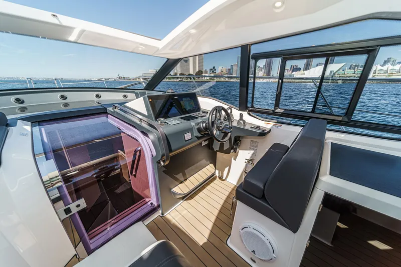 Slide: The Image of 2023 Bavaria SR36 yacht interior with modern helm, city skyline view. - 33