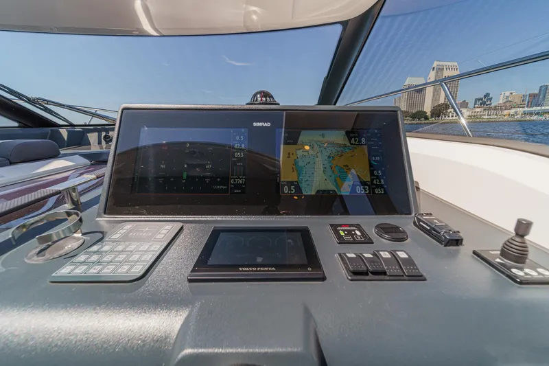Slide: The Image of Helm of 2023 Bavaria SR36 yacht with navigation screens and controls. - 35