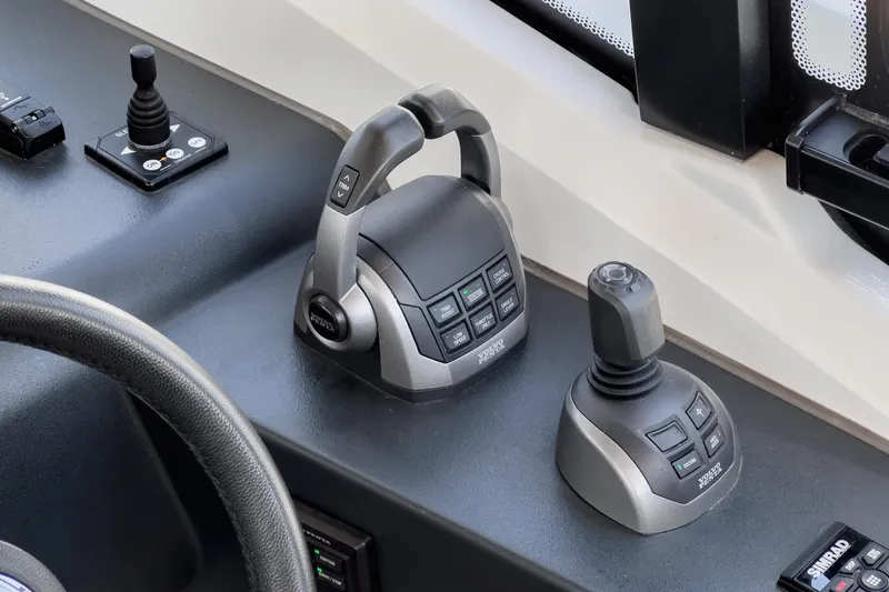 Slide: The Image of Control panel of 2023 Bavaria SR36 boat with joystick and throttle controls. - 37