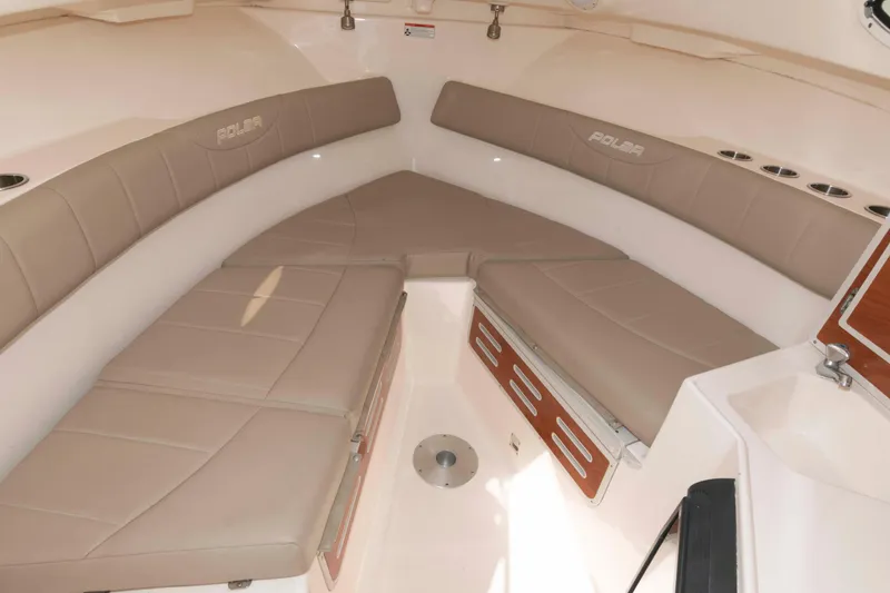 Slide: The Image of 2008 Polar 2300 Walkaround boat interior with beige seating and storage compartments. - 12