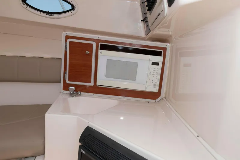 Slide: The Image of 2008 Polar 2300 Walkaround cabin interior with microwave and sink. - 13
