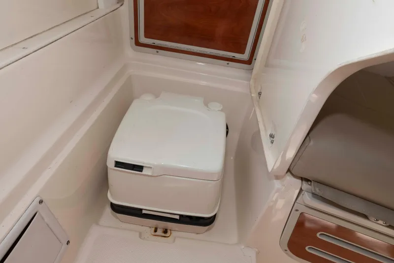 Slide: The Image of 2008 Polar 2300 Walkaround boat interior with portable toilet. - 14