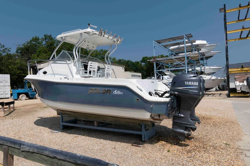 Slide: The Image of 2008 Polar 2300 Walkaround boat with Yamaha engine on display in a marina. - 2