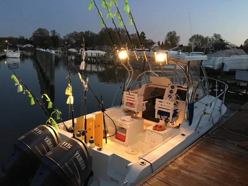Slide: The Image of 2008 Polar 2300 Walkaround boat docked at sunset with fishing gear and Yamaha engines. - 4