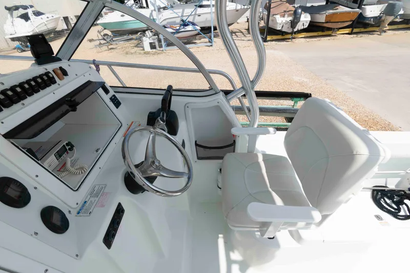 Slide: The Image of 2008 Polar 2300 Walkaround boat cockpit with steering wheel and seating. - 7