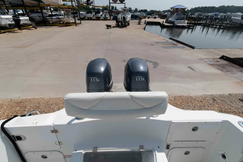 Slide: The Image of 2008 Polar 2300 Walkaround boat with twin Yamaha 115 engines at a marina. - 9