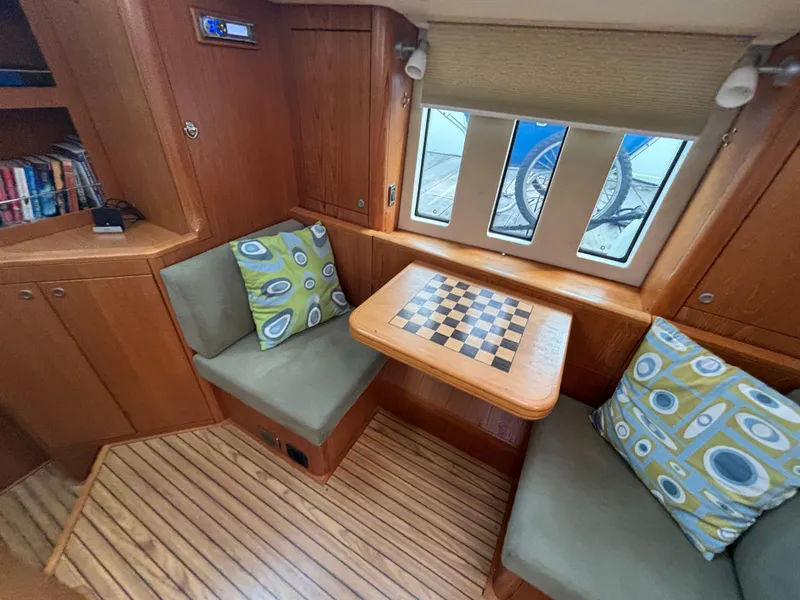 Slide: The Image of Cozy interior of 2014 Southerly 535 yacht with chessboard table and patterned cushions. - 14