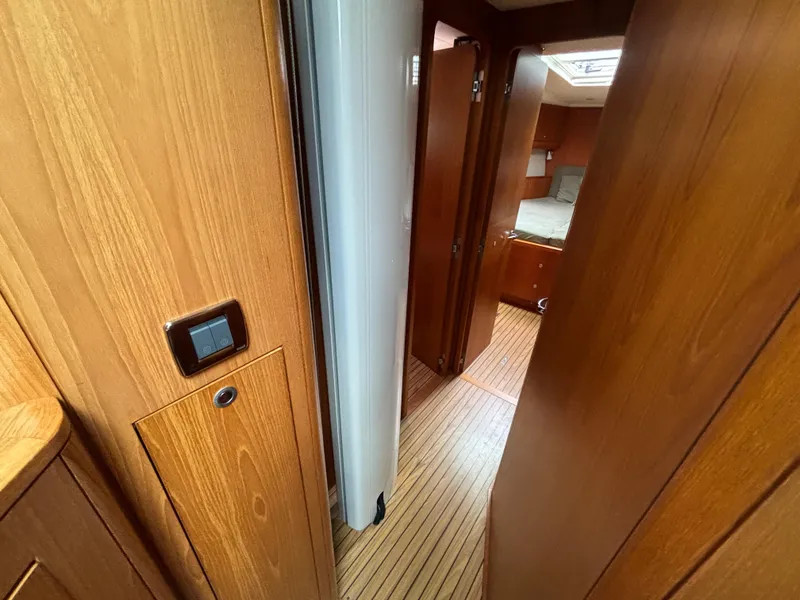 Slide: The Image of Interior of 2014 Southerly 535 yacht, featuring wooden paneling and cozy cabin space. - 17