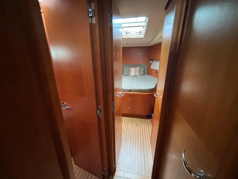 Slide: The Image of Interior of 2014 Southerly 535 yacht, featuring a cozy cabin with wooden finishes. - 18