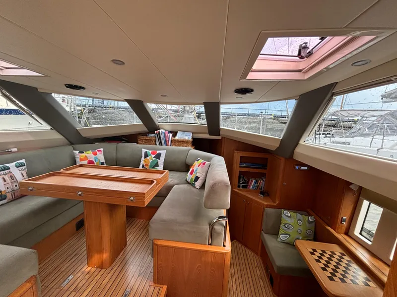 Slide: The Image of Luxurious 2014 Southerly 535 yacht interior with cozy seating, wooden table, and colorful cushions. - 2