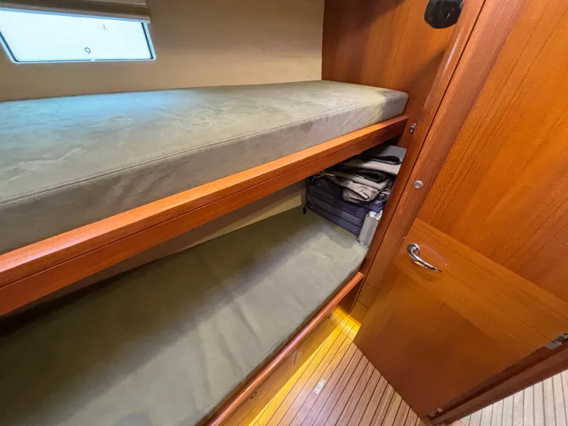 Slide: The Image of Bunk beds in 2014 Southerly 535 yacht cabin with wooden interior and storage space. - 25