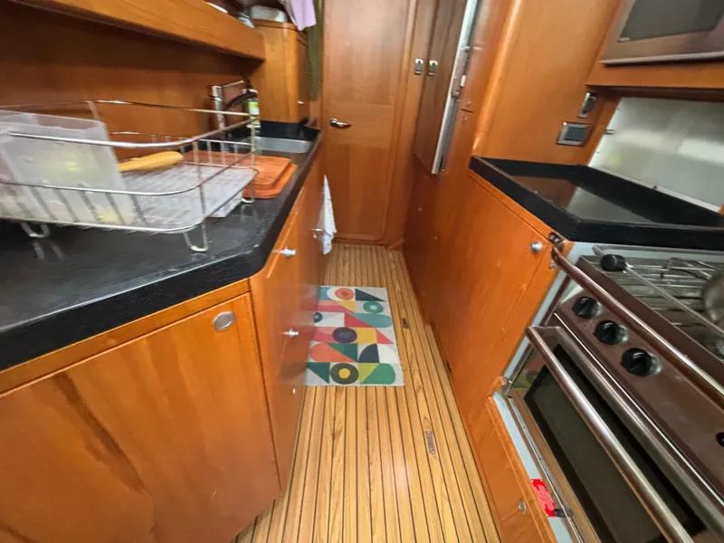 Slide: The Image of Galley kitchen in 2014 Southerly 535 yacht with wooden cabinets and modern appliances. - 34
