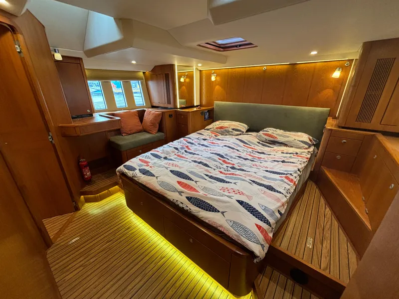Slide: The Image of Luxurious 2014 Southerly 535 yacht cabin with cozy bed and elegant wood interior. - 35