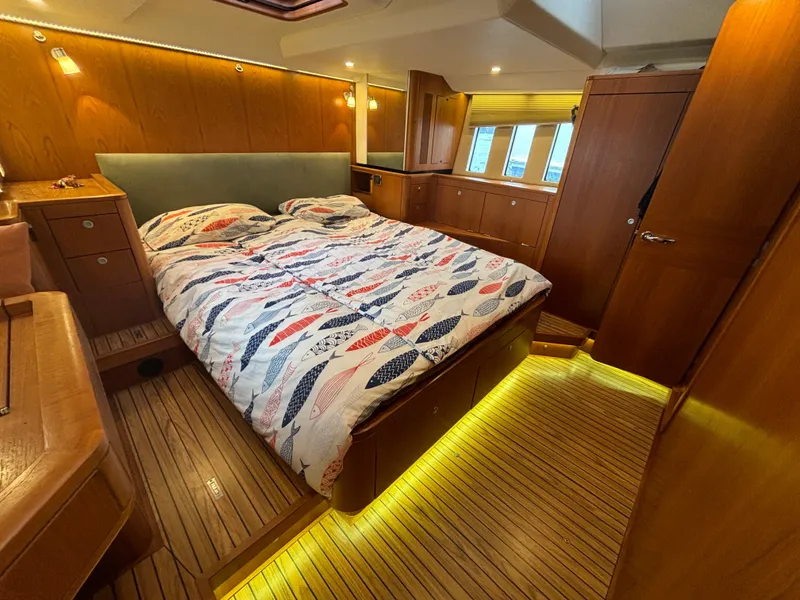 Slide: The Image of Luxurious 2014 Southerly 535 yacht bedroom with wood paneling and ambient lighting. - 38