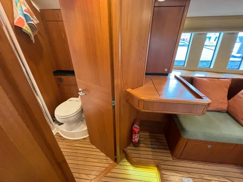 Slide: The Image of Interior of 2014 Southerly 535 yacht with wooden finish, seating, and bathroom. - 40
