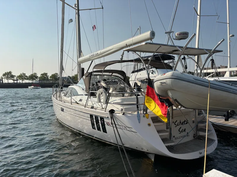 Slide: The Image of 2014 Southerly 535 yacht docked, displaying German flag, with clear sky and calm waters. - 5